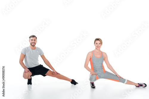 sportive couple warming up before training isolated on white