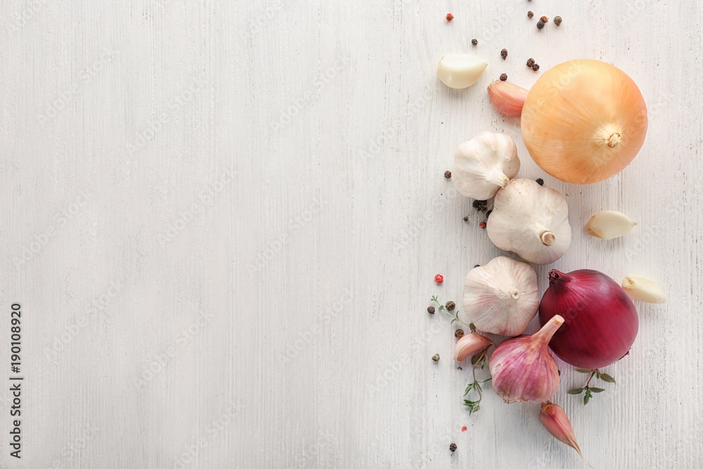 Fresh garlic, onion and pepper grains on light background, top view Fresh garlic, onion and pepper grains on light background, top view