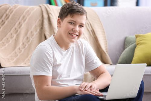 Teenage boy with laptop at ...