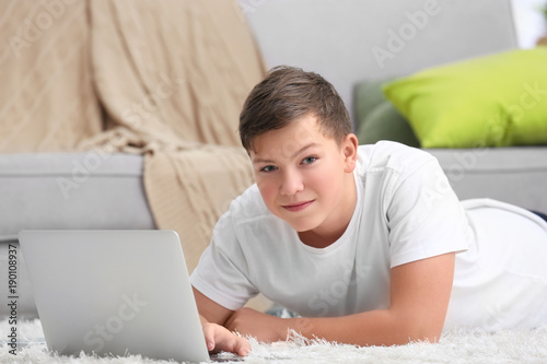 Teenage boy with laptop at ...