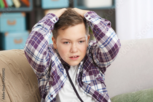 Upset teenage boy in casual...