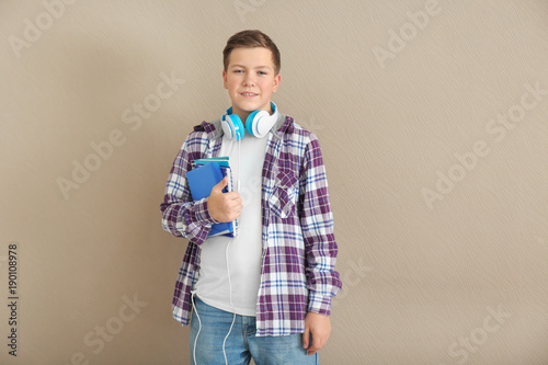 Teenage boy with notebooks ...