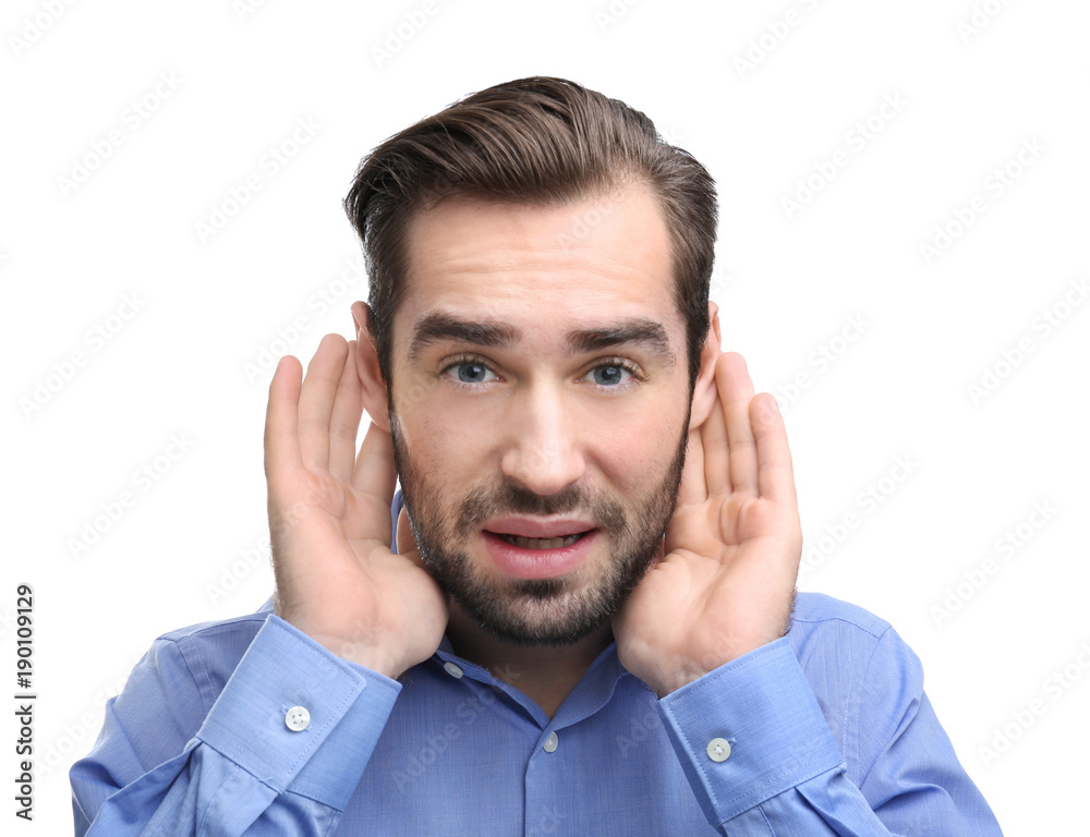 Young man with hearing problem on white background Young man with hearing problem on white background
