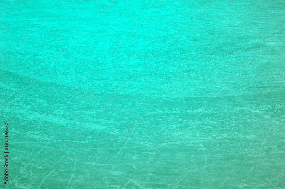 A section of ice on the rink, covered with multiple scratches.