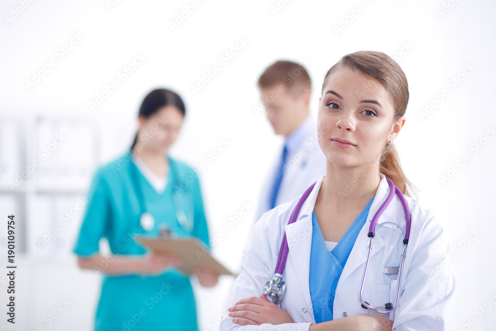 Attractive female doctor in front of medical group. Attractive female doctor in front of medical group.