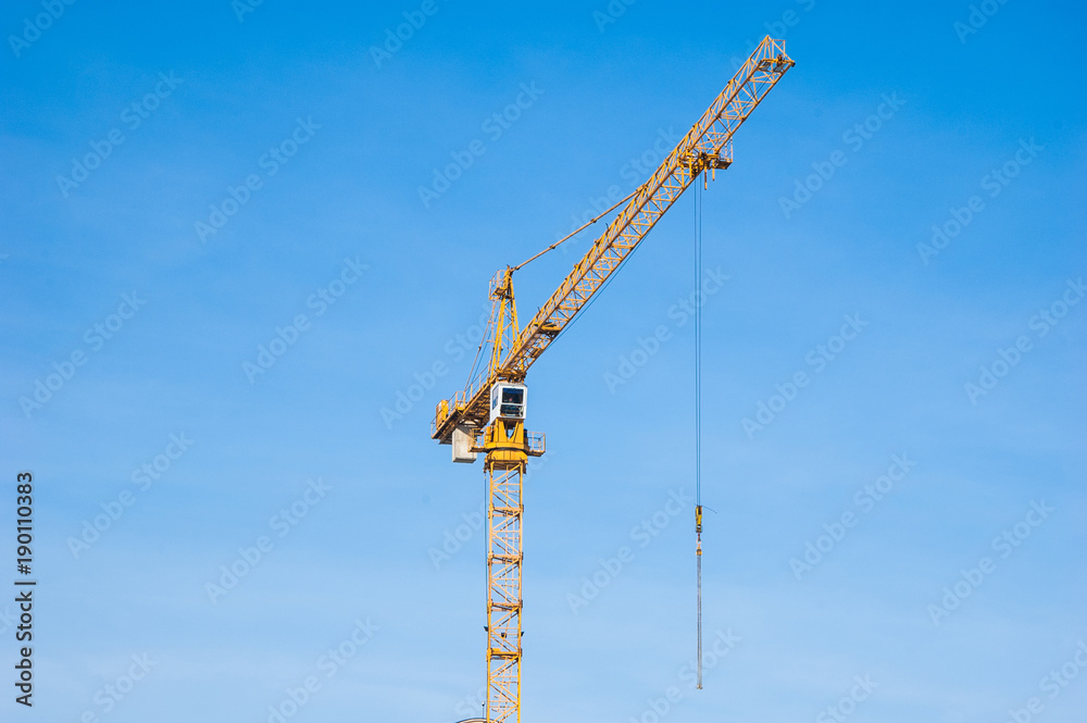 Building crane near a multi-storey residential building. Building crane near a multi-storey residential building.