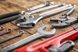 Plumber's tools on wooden background