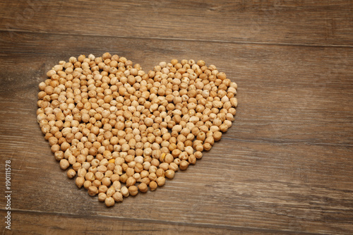 Heart of chickpeas on brown wooden table