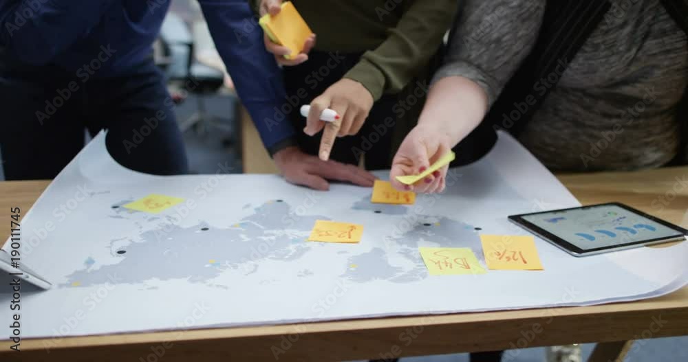 4K Close up hands of business team looking at world map, using tablet & brainstorming with sticky notes. Slow motion. 4K Close up hands of business team looking at world map, using tablet & brainstorming with sticky notes. Slow motion.