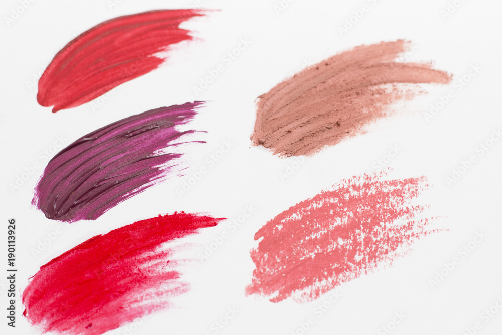 Make Up Beauty Fashion Concept. Matte red, pink, beige and burgundy lipstick smear on white. Color brushstroke Make Up Beauty Fashion Concept. Matte red, pink, beige and burgundy lipstick smear on white. Color brushstroke