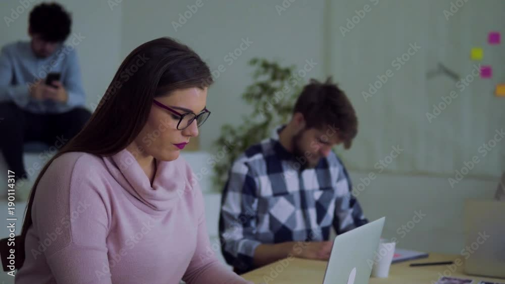 Group of young people working together in an office. Group of young people working together in an office.