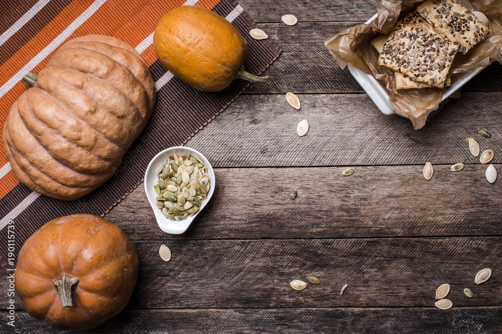 pumpkins with cookies and seeds on wooden table pumpkins with cookies and seeds on wooden table