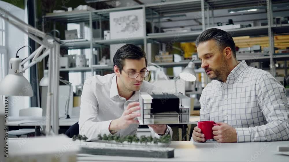 Two men working in design and engineering architecture office Two men working in design and engineering architecture office