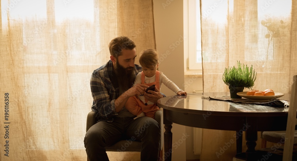 Father and son using mobile phone Father and son using mobile phone