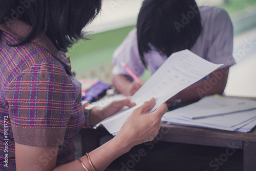 Thai Reading Examination between teacher and student grade 4 .Outside the classroom in primary school.