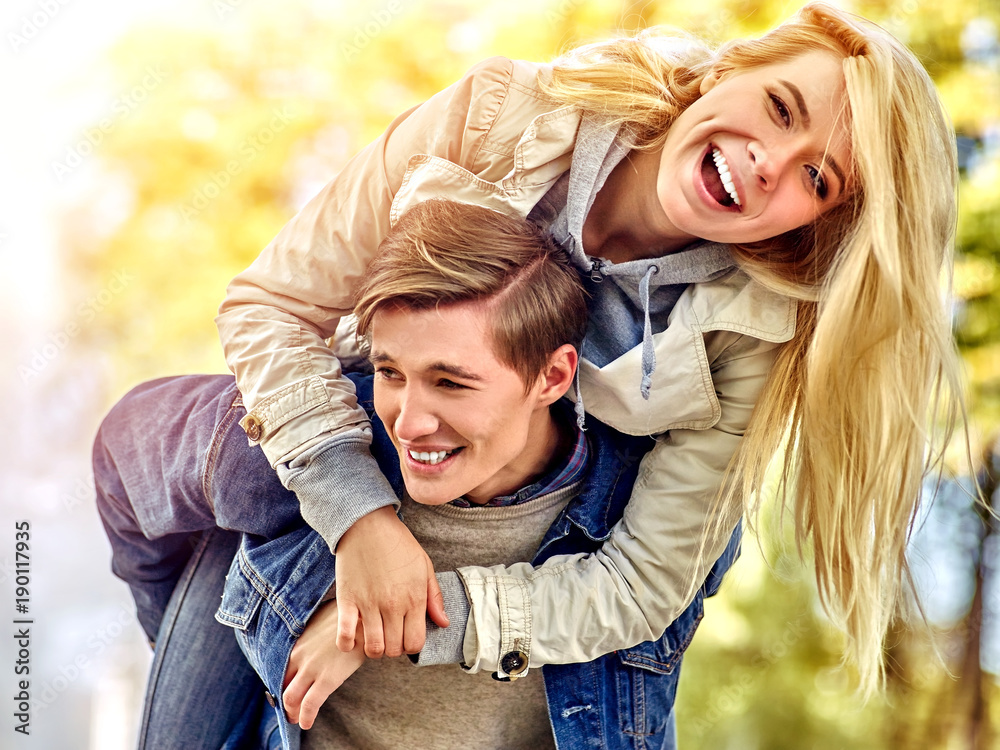 Fototapeta premium Adventure trips for couples. Spring people walking park and kissing. Summer friends walk outdoor. Weekends first date of two young person in good weather day. Toning of the spring photo.