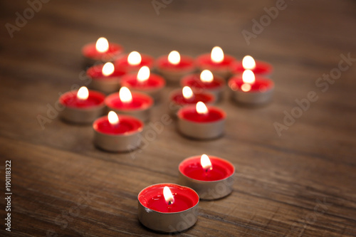 Red candles on brown wooden table