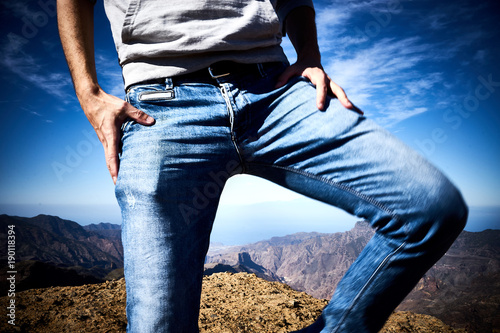 Wearing jeans outdoors / Man in casual jeans - close-up with blurred motion