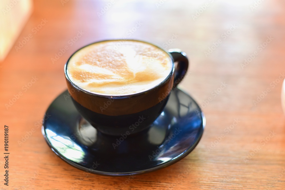 Isolated Cup of Latte Macchiato on Wooden Table Isolated Cup of Latte Macchiato on Wooden Table