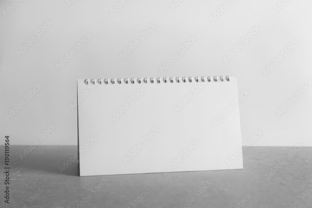 Blank desk calendar on table against white background. Mockup for design Blank desk calendar on table against white background. Mockup for design