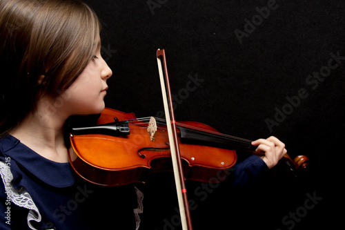 Little pretty girl playing violin