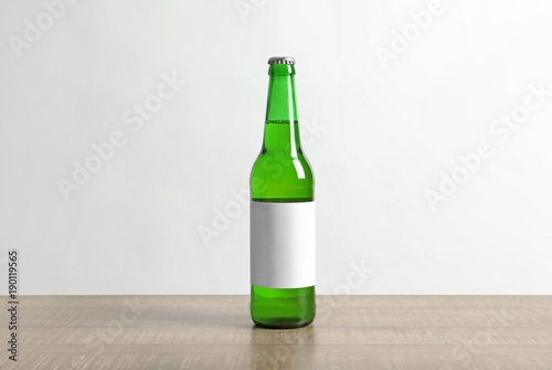 Bottle of drink on table against white background. Mockup for design