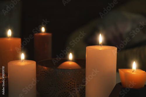 Burning candles on blurred background