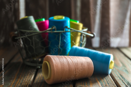 Color sewing threads on wooden table