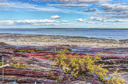 Landscape view of Saint Lawrence river from Ile D'Orleans, Quebec, Canada in summer with red rocks © Kristina Blokhin
