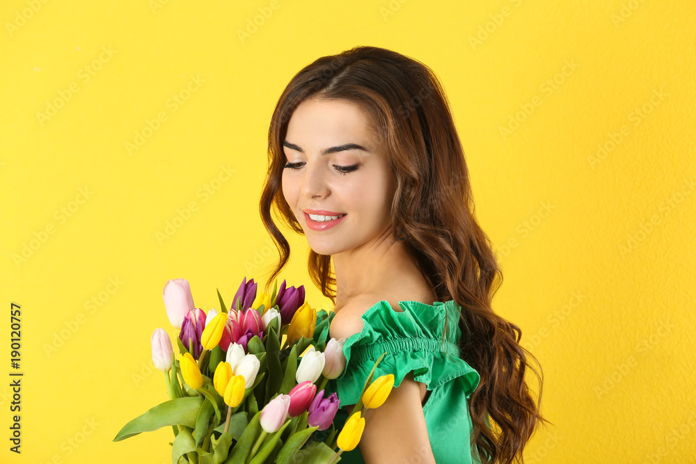 Beautiful woman holding bouquet of tulips on color background Beautiful woman holding bouquet of tulips on color background
