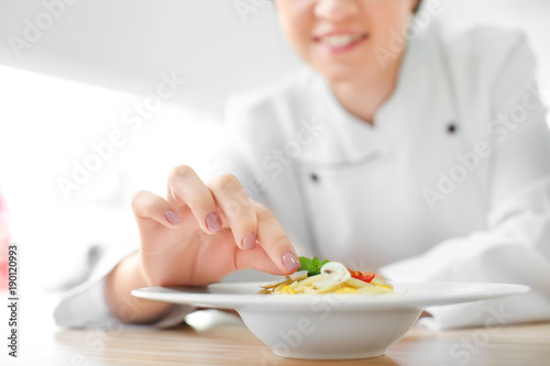 Female chef preparing tasty...
