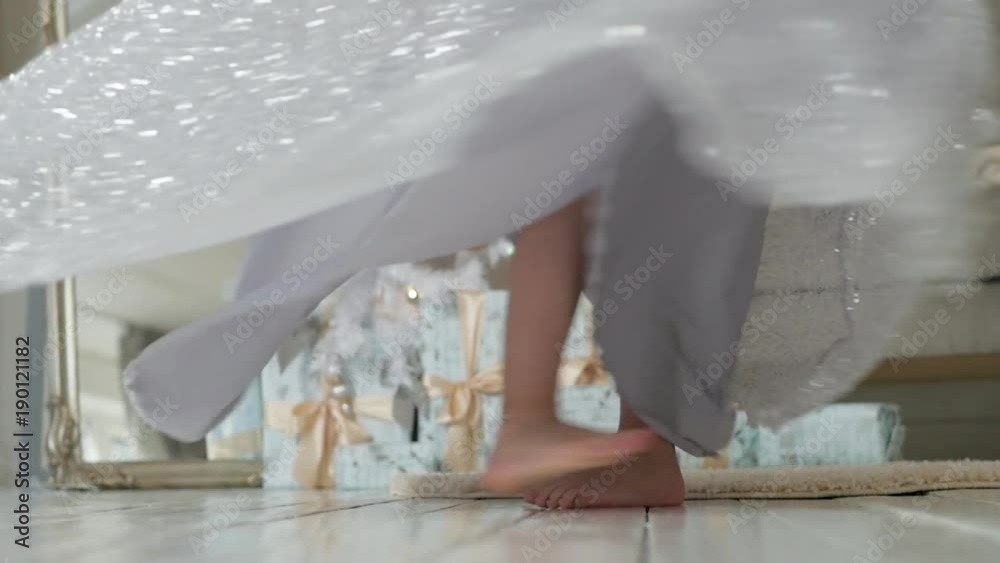 the girl is dancing in a beautiful shiny dress. Christmas interior