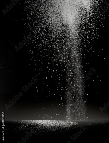 flour dust falling on a black table