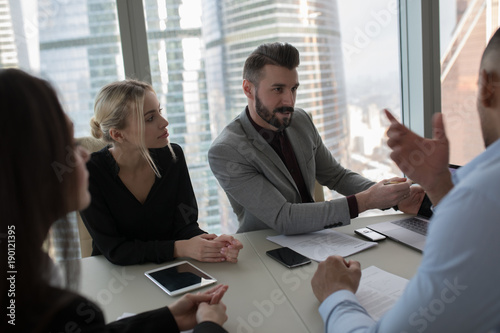 Wallpaper Mural The business people sit at the table and work in the office. Torontodigital.ca