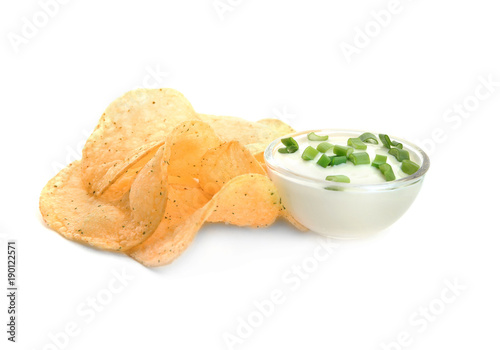 Potato chips and sour cream with onion in bowl on white background