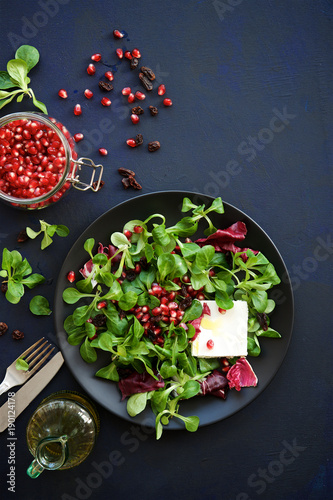 Fresh salad with pomegranate, raisins and feta cheese. Detox food concept 