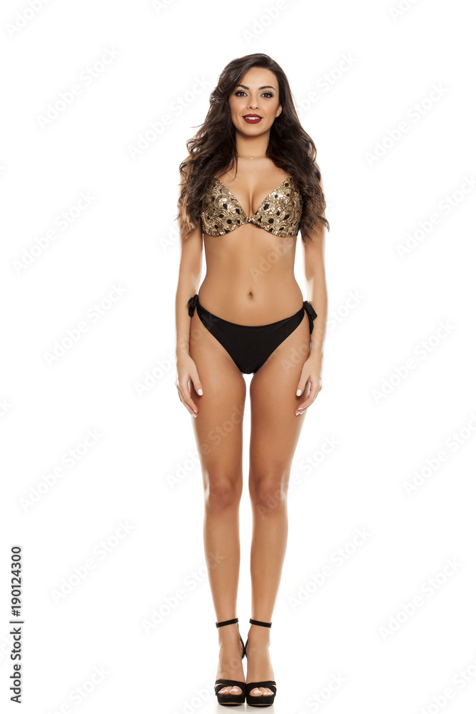 Beautiful fashion model in black bikini on white background Beautiful fashion model in black bikini on white background