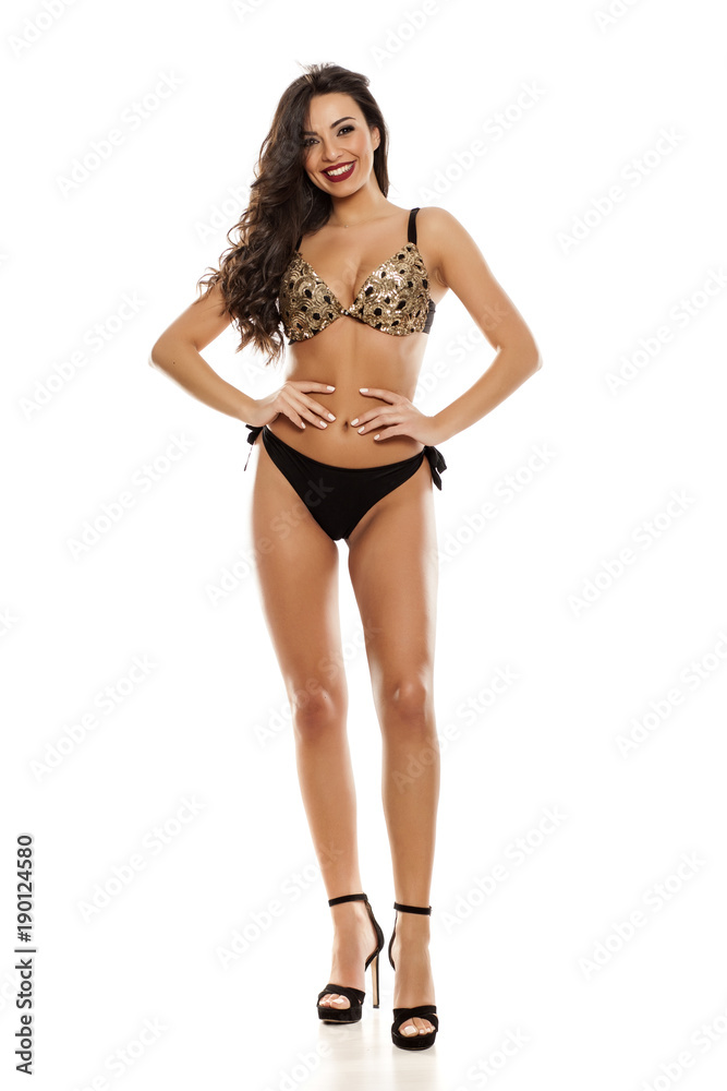 Beautiful fashion model in black bikini on white background Beautiful fashion model in black bikini on white background