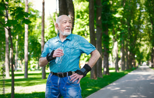 Senior man in casual wear with water bottle