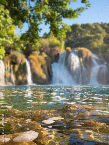 Waterfall in Krka National Park  famous Skradinski buk  one of the most beautiful waterfalls in Europe and the biggest in Croatia  blurred defocused background  vertical image