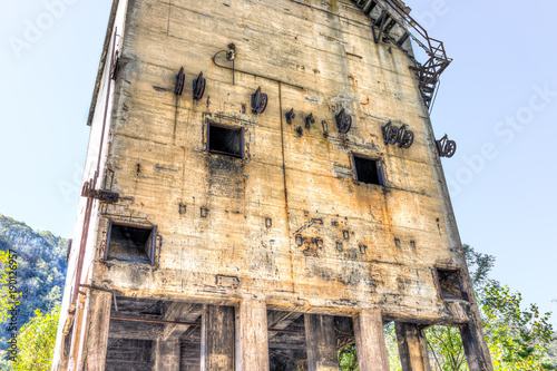 Abandoned retro vintage concrete loading receiving terminal building exterior in Thurmond, West Virginia ghost town with decaying structure walls, windows photo