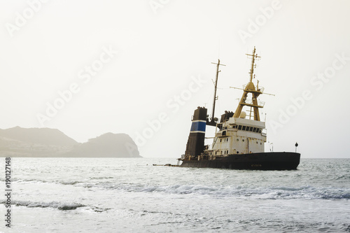 An abandoned ship is anchored close to shore in Mindelo, part of Cape Verde, Africa.