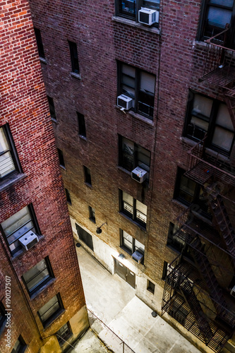 Photography Aerial view down of illuminated brick apartment condo building architecture in F