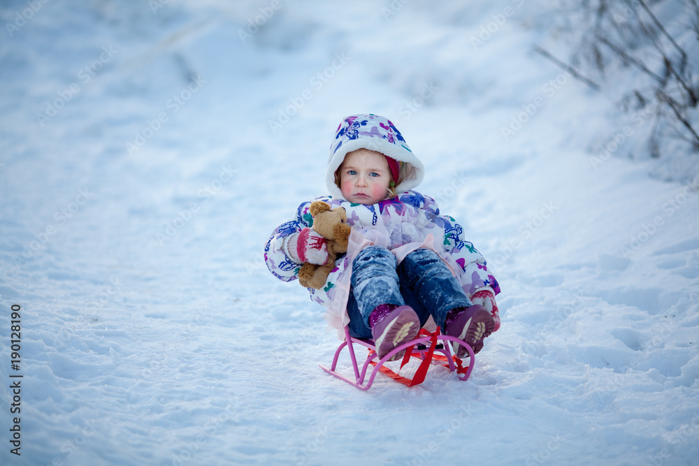 Winter Walk of small pretty ruddy girl, child plays with soft toy Winter Walk of small pretty ruddy girl, child plays with soft toy