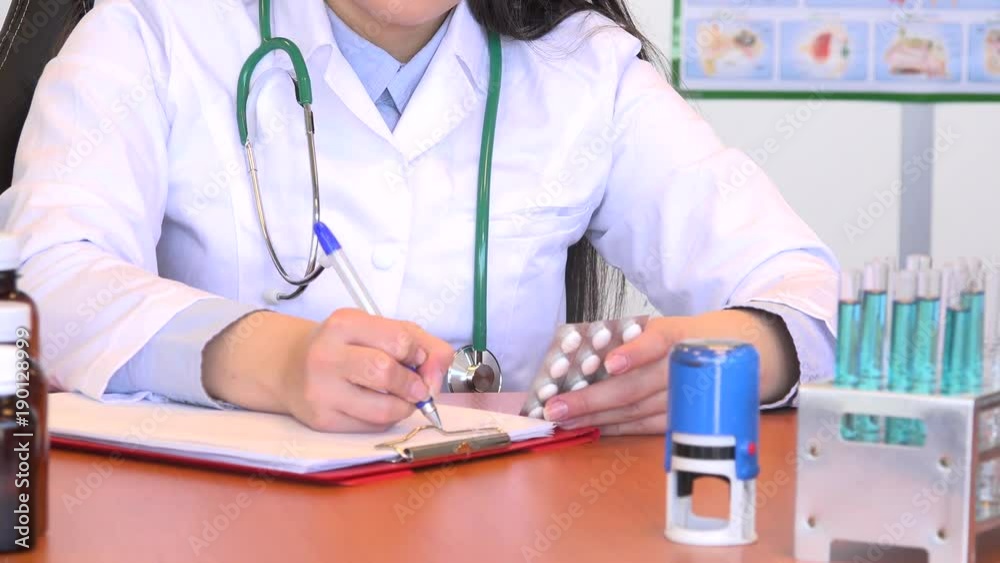 Pills prescription writing close up doctor practitioner hands with pills office Pills prescription writing close up doctor practitioner hands with pills office