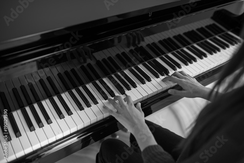 Piano music pianist hands playing. Musical instrument grand piano details with performer hand on white background photo