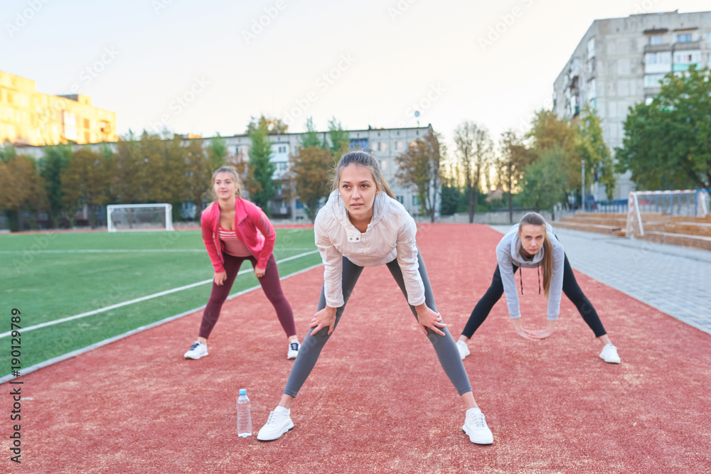 Positive women doing sport exercises.