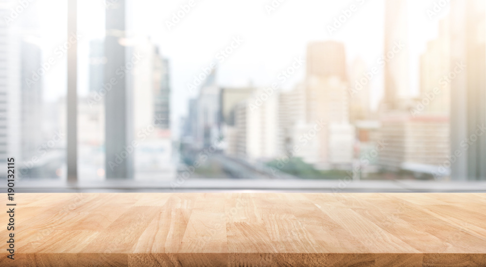 Empty wood table with blur room office and window city view background.For montage product display or design key visual - obrazy, fototapety, plakaty 
