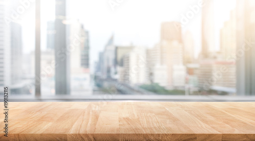 Empty wood table with blur room office and window city view background.For montage product display or design key visual