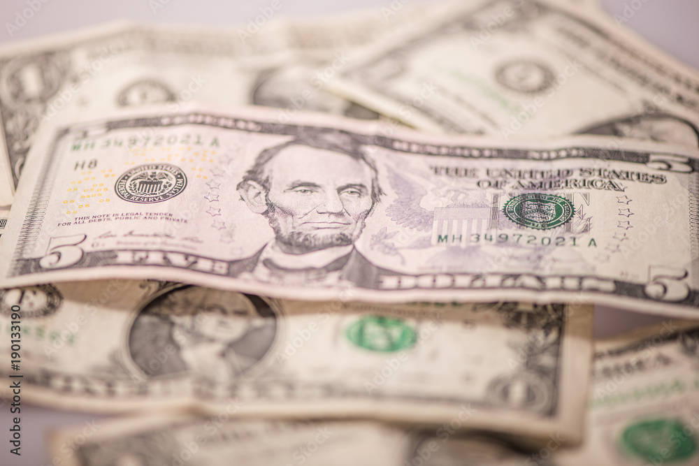 us dollar bank notes and coins on white background us dollar bank notes and coins on white background